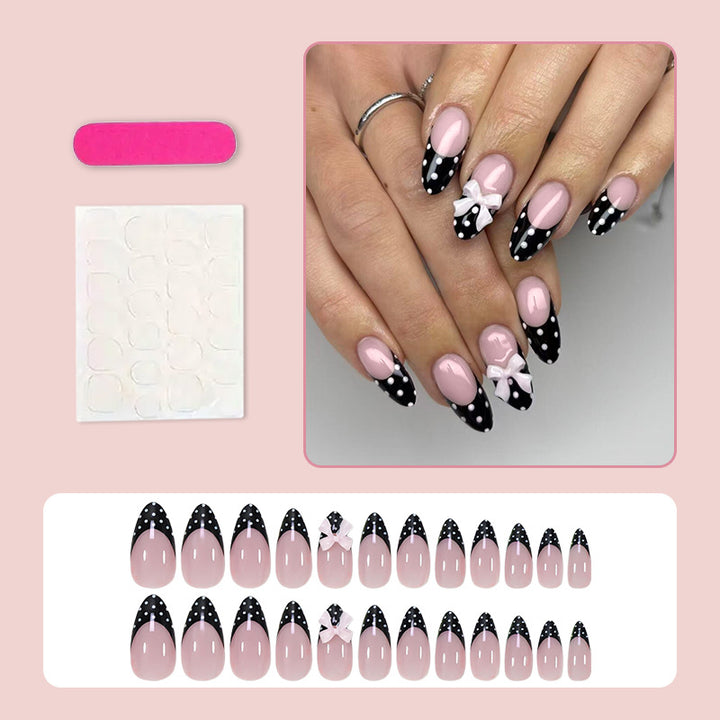 Artificial nail set with glamorous black and white polka dot accents Stornfield
