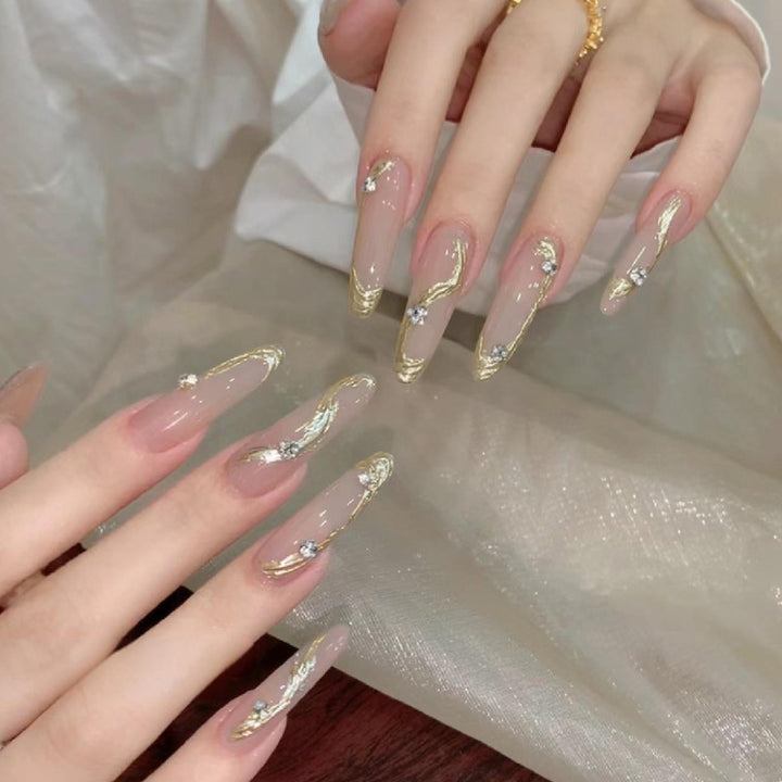 Artificial nail set with elegant gold design and sparkling applications Stornfield