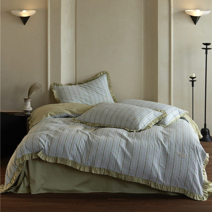 Bedding set with fine striped texture, ruffled border and breathable cotton blend