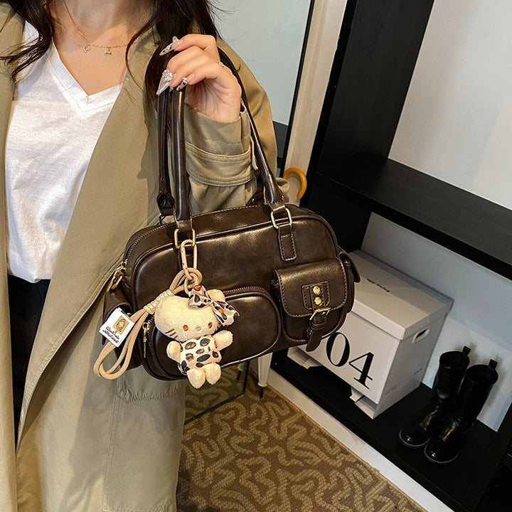 Elegant Handbag with Playful Charms and Multiple Compartments Stornfield