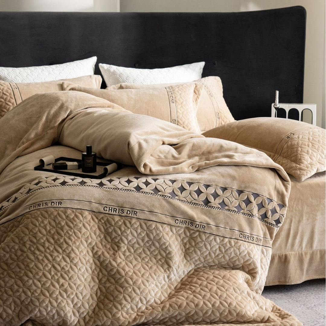 Quilted bedding set with geometric quilting and decorative ribbon