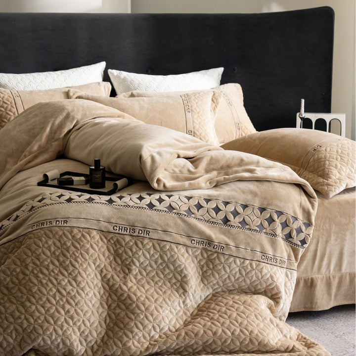 Quilted bedding set with geometric quilting and decorative ribbon