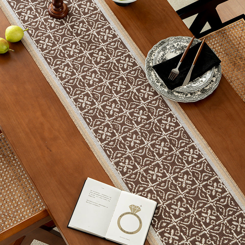 Decorative table runner with woven ornament jacquard and finely hemmed edges Stornfield