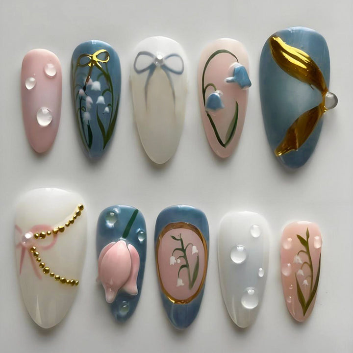 Acrylic nail set with floral design and elegant gold embellishments Stornfield