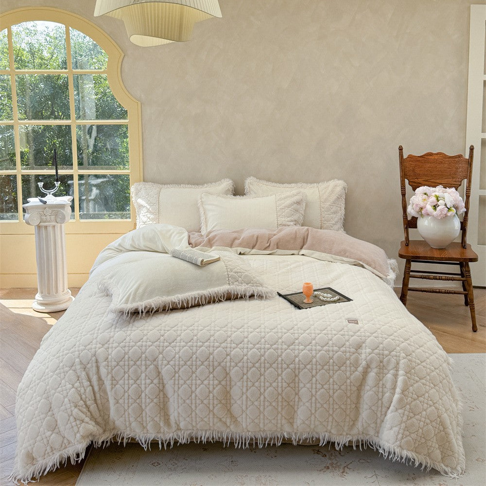 Quilted bedding with fringes and decorative pillows