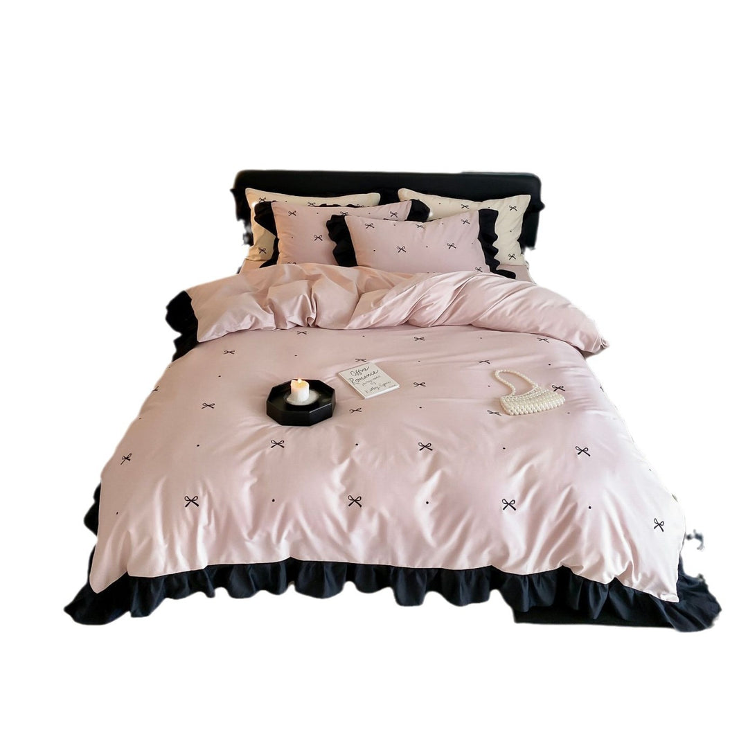 Reversible cotton satin bedding set with fine bow embroidery and ruffled edge