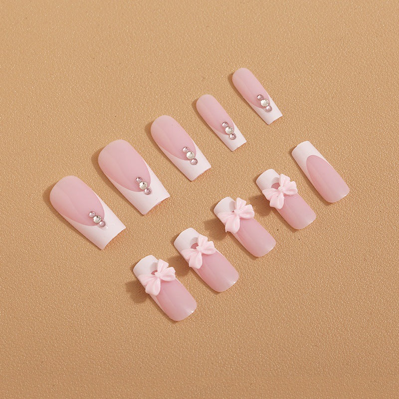 Trendy French-design artificial nails with bow accents Stornfield