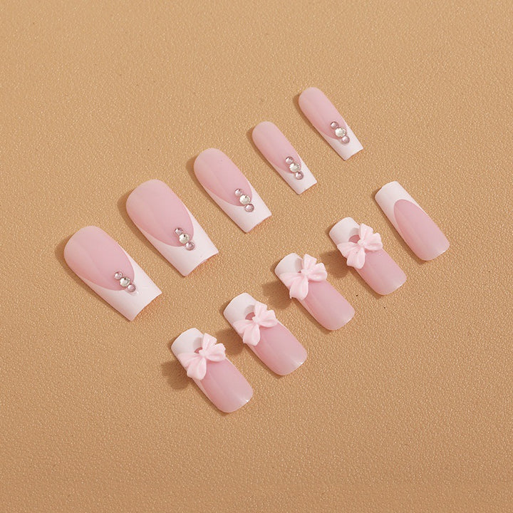 Trendy French-design artificial nails with bow accents Stornfield