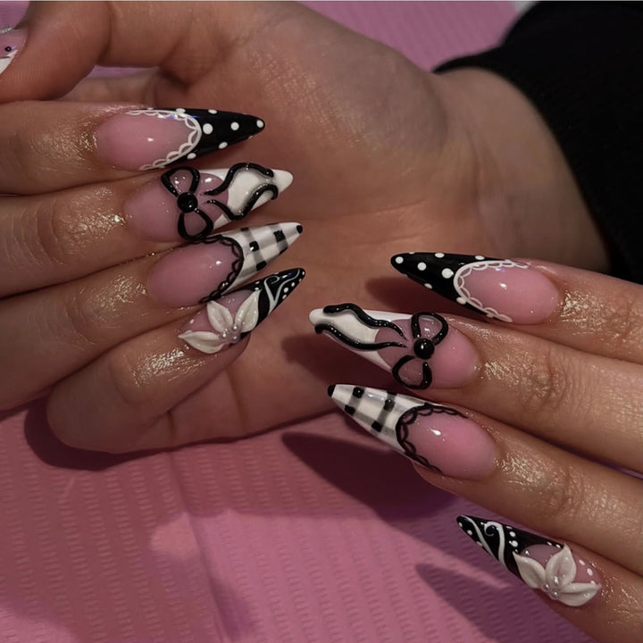 Artful stiletto nails with floral and geometric accents Stornfield