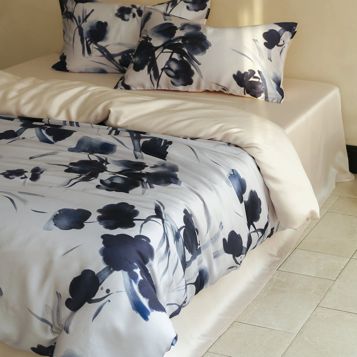 Satin bed linen set with ruffled bed skirt and floral printed pillowcases