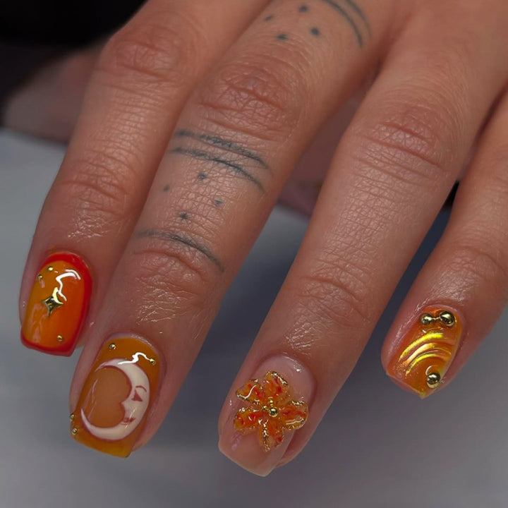 Artificial nails with floral motifs and glitter accents Stornfield