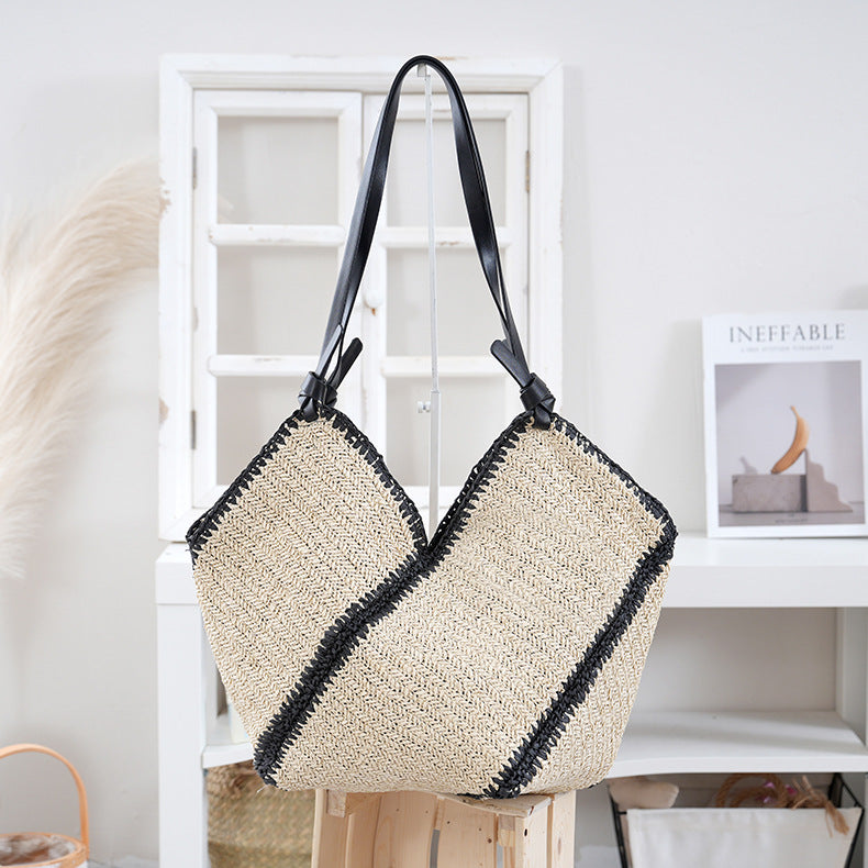 Handbag made of braided natural material with contrasting leather handles Stornfield