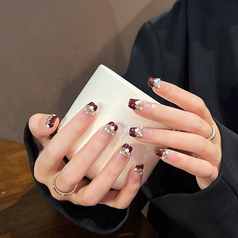 Glamorous artificial nails with decorative pearl and glitter embellishments Stornfield