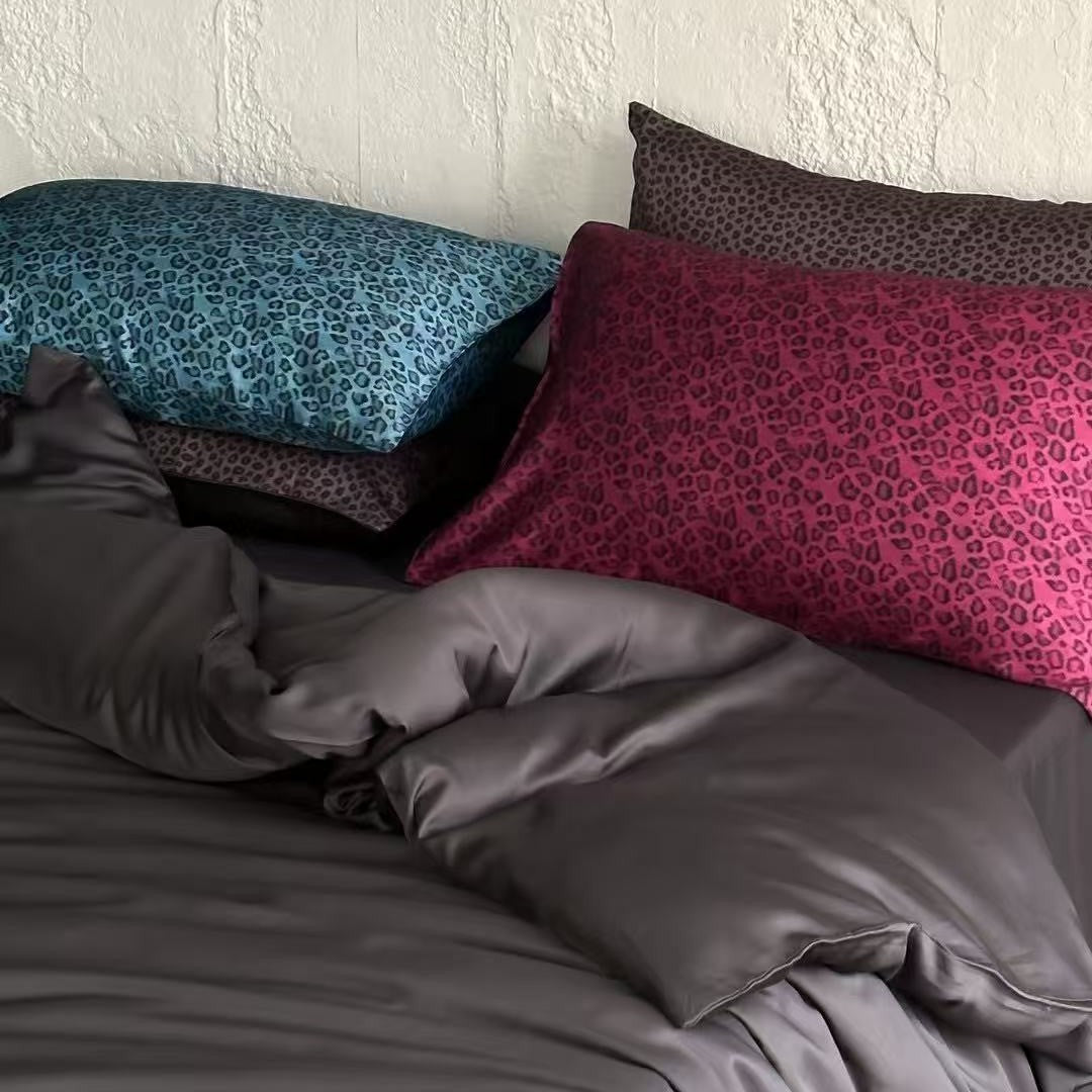 Satin bedding set with a silky sheen, smooth drape, and animal print pillows