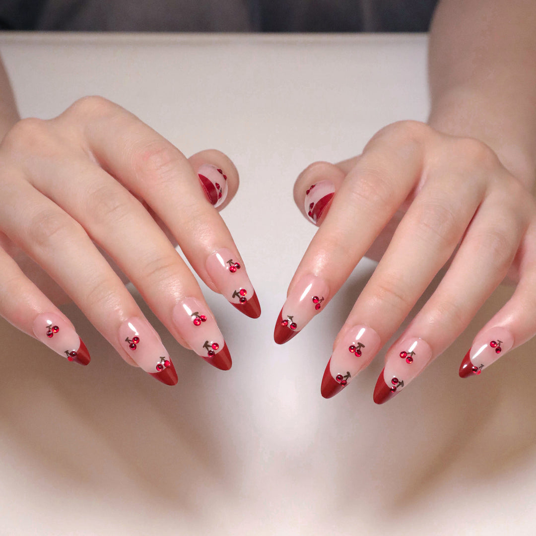 Artful stiletto nails with cherry motifs and glitter accents Stornfield