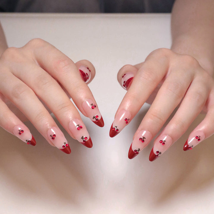 Artful stiletto nails with cherry motifs and glitter accents Stornfield