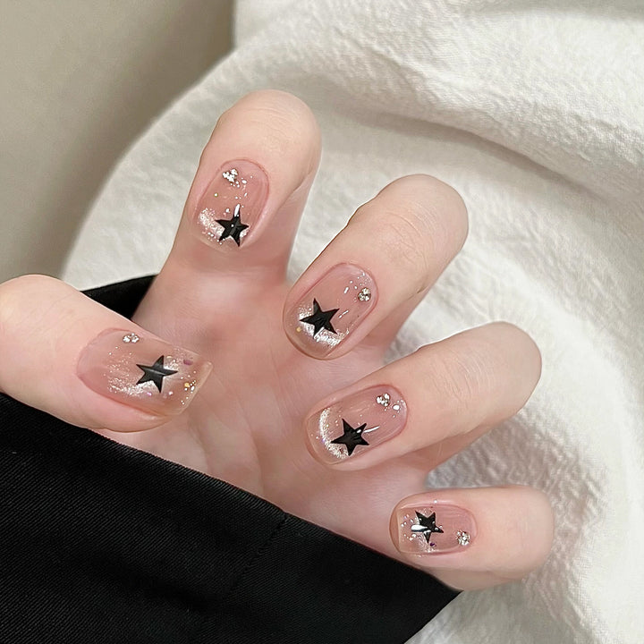 Artistic acrylic nails with glamorous star motifs Stornfield