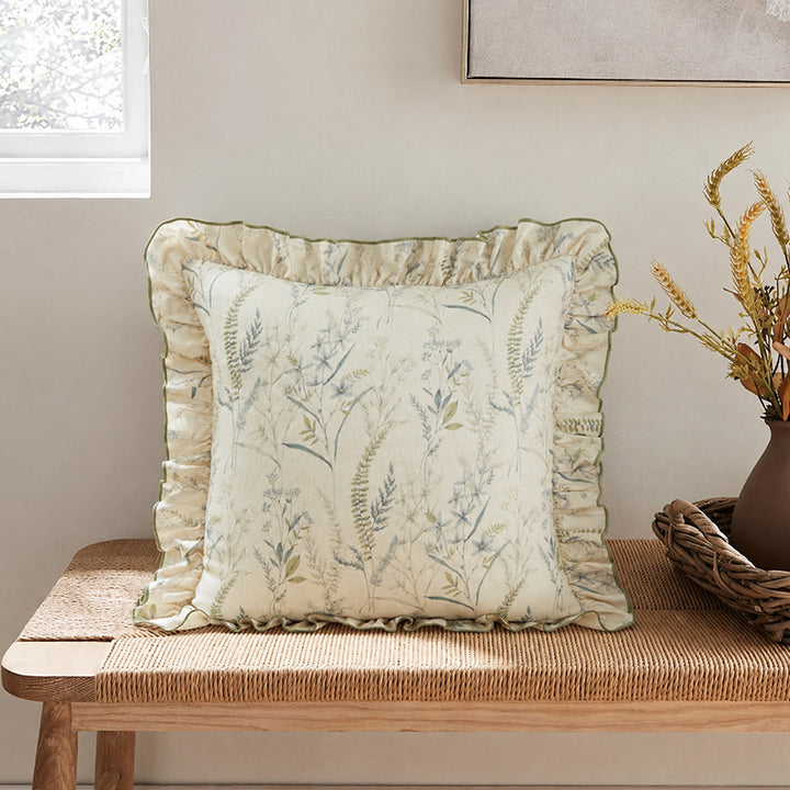 Decorative pillow with ruffles and floral linen cover