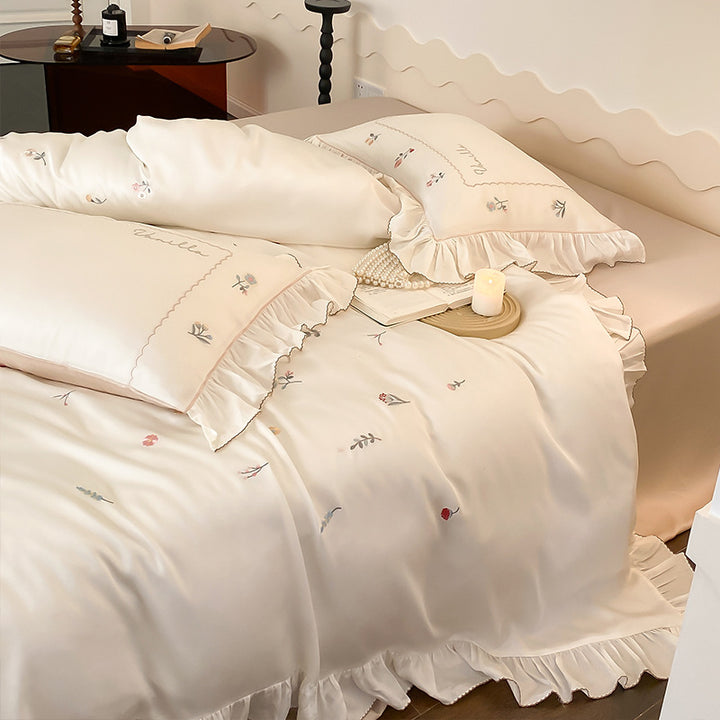 Romantic cotton satin bedding set with delicate floral embroidery and ruffle trim