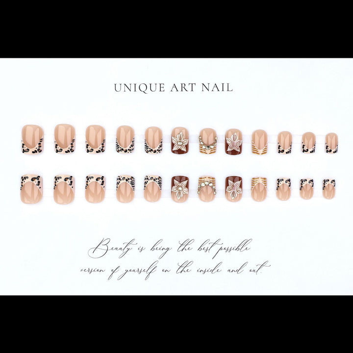 Artificial nail set with floral embellishments and elegant glitter details Stornfield