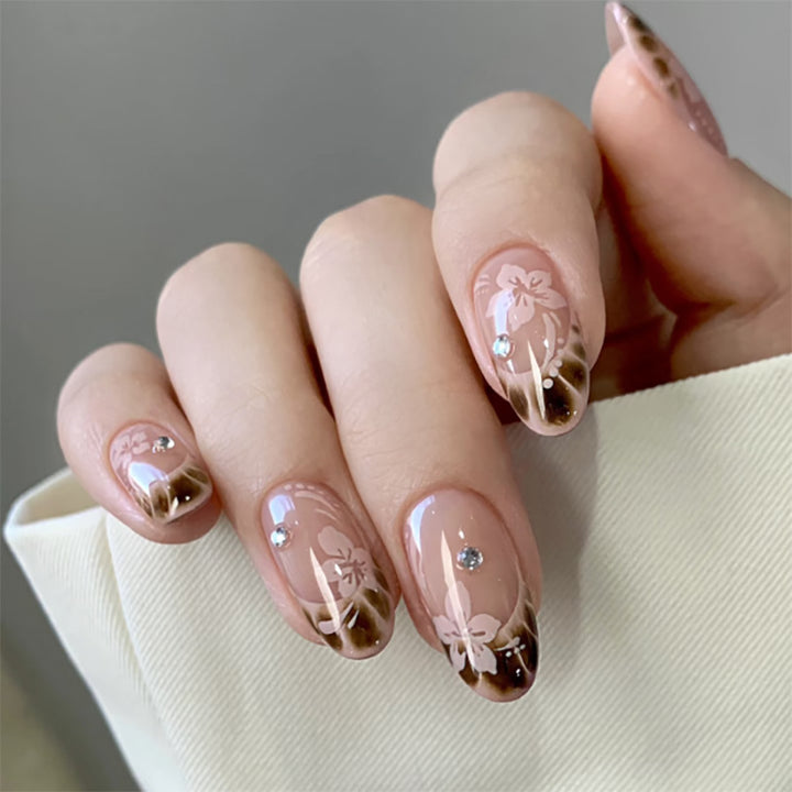 Elegant Artificial Nail Art with Floral Design and Glitter Accents Stornfield