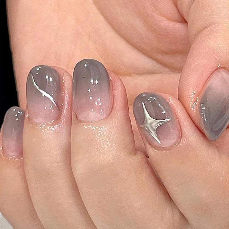 Artificial nail art with elegant ombre design and charming accents Stornfield