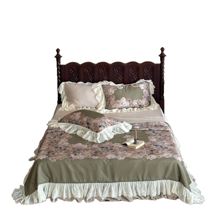 Vintage-inspired satin bedding with elaborate ruffled flounces and rose embroidery
