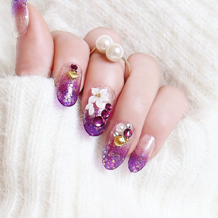 Artistic Press-On Nail Design with Glitter and Floral Accents