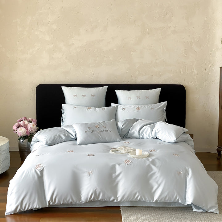 Cotton satin bedding set with delicate bow and flower embroidery as well as pillowcases