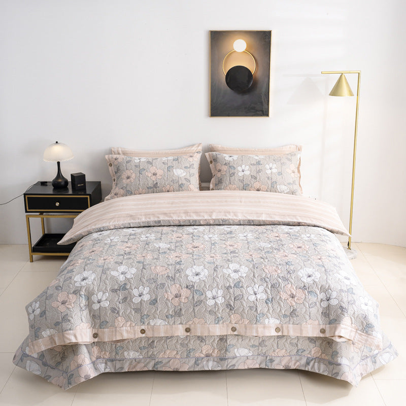 Quilted bedspread and bedding set with floral print, reversible function and decorative button placket
