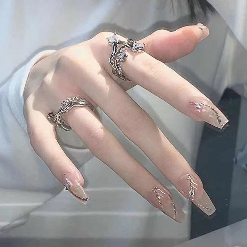 Glamorous artificial nails with delicate flower and glitter effects Stornfield