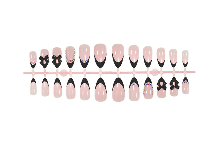 Artificial nail set with glamorous bow design and sparkling accents Stornfield