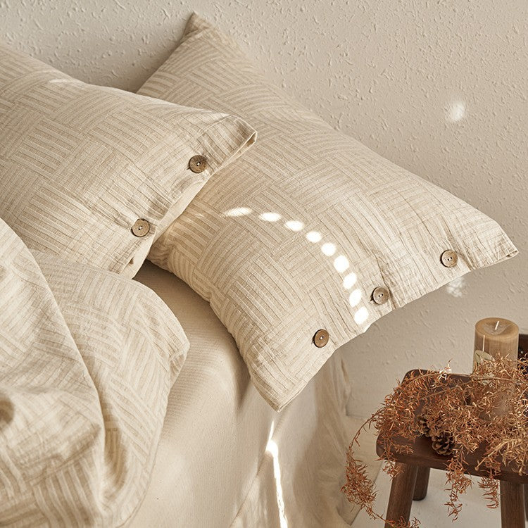 Linen-look bedding set with natural wood button closure and fine texture