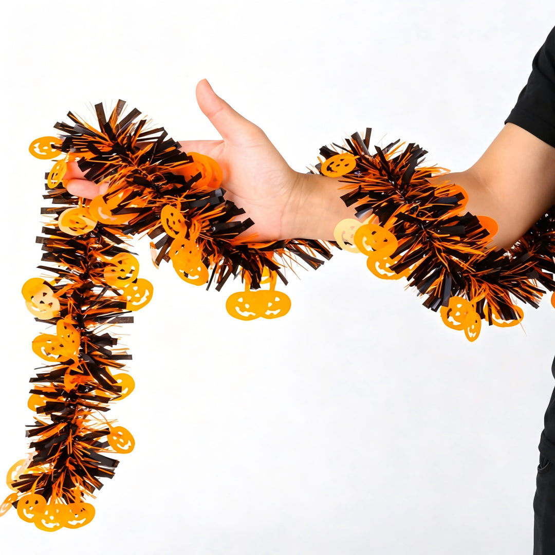 Shiny Halloween garland made of plastic with pumpkin confetti and dense fringes