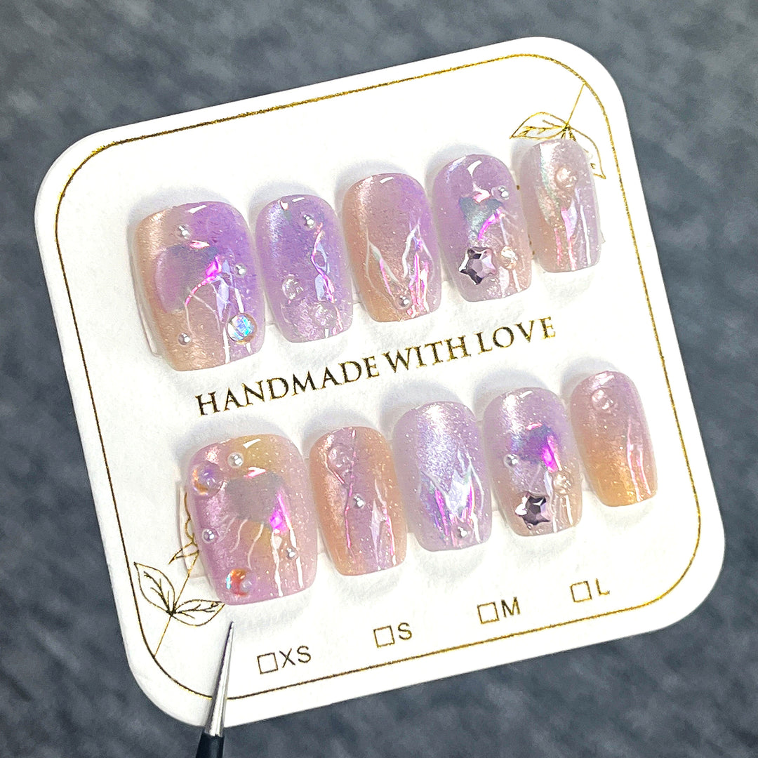 Artificial nail art with sparkling accents and transparent color gradient Stornfield