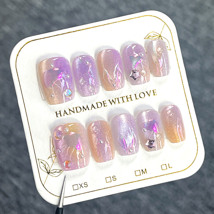 Artificial nail art with sparkling accents and transparent color gradient Stornfield