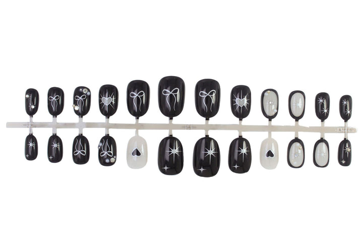 Artificial nail set with elegant bow and heart design Stornfield