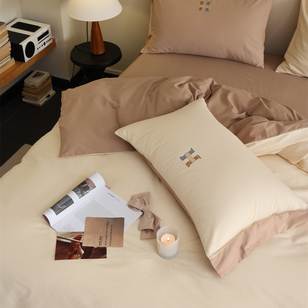 Luxurious cotton satin bedding set with contrasting piped edge and monogram embroidery