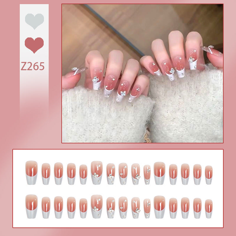 Nail art set with elegant wave patterns and delicate pearl accents Stornfield