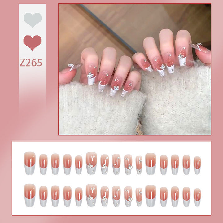 Nail art set with elegant wave patterns and delicate pearl accents Stornfield