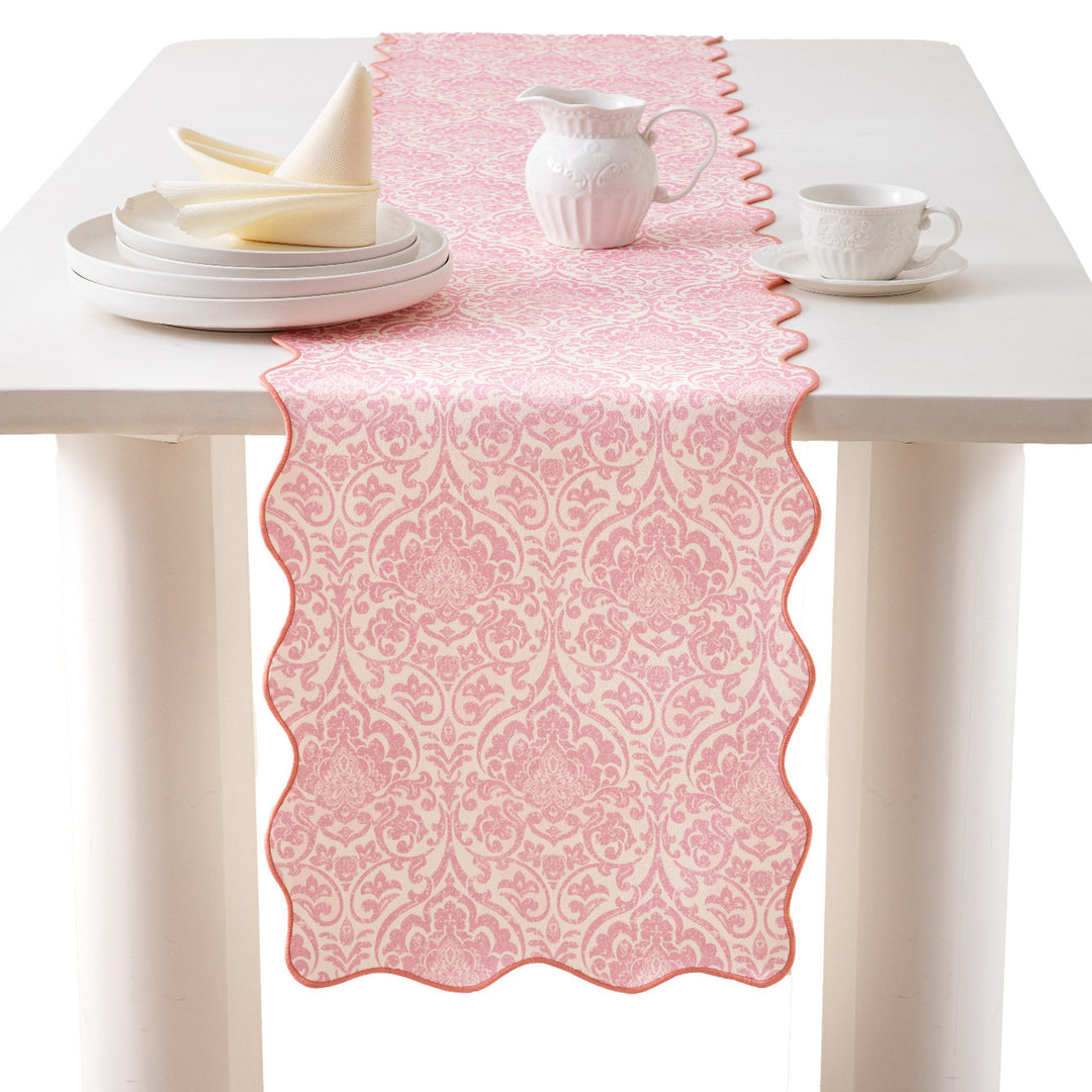 Elegant table runner with wavy hem and baroque damask pattern