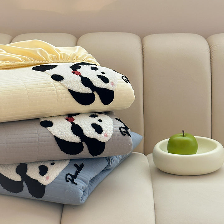 Padded mattress pad with ribbed structure, elastic fitted edge, and panda embroidery