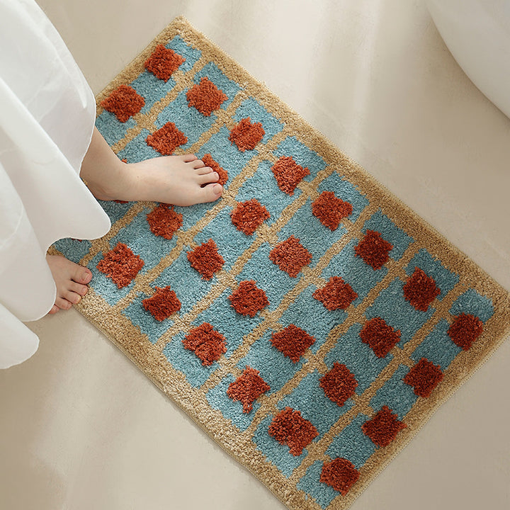 Hand-tufted bathroom bath mat with non-slip backing and textured square relief Stornfield