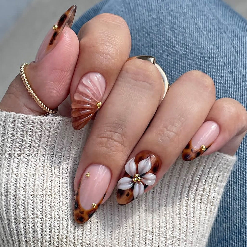 Nail art set with detailed ombre design and creative flower accents Stornfield