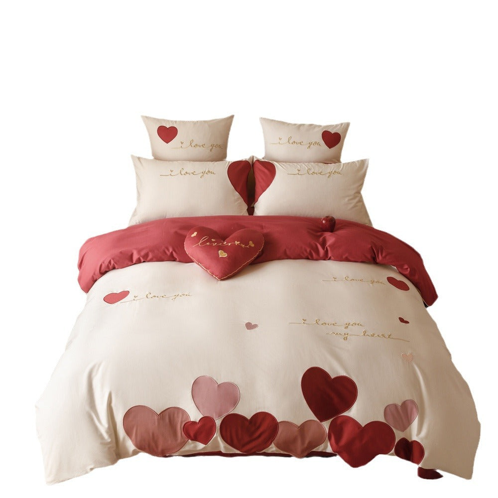 Romantic bedding set made of cotton satin with appliquéd hearts and golden embroidery