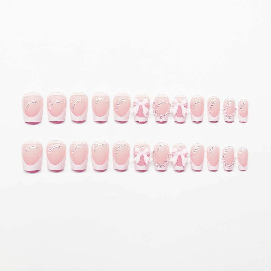 Artificial nails with elegant bows and pearl embellishments Stornfield
