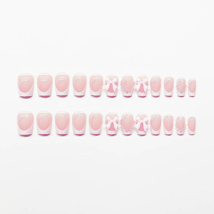 Artificial nails with elegant bows and pearl embellishments Stornfield