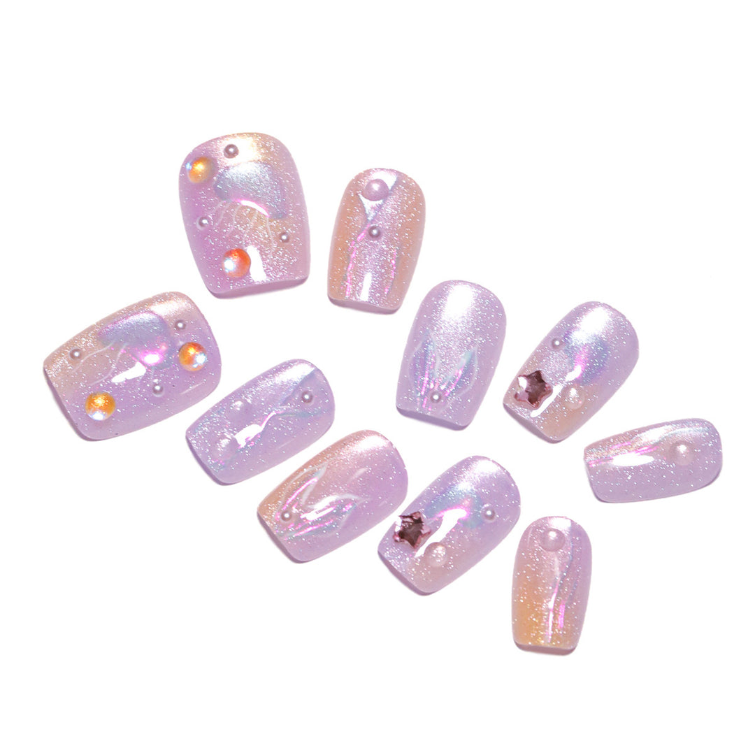 Artificial nail art with sparkling accents and transparent color gradient Stornfield