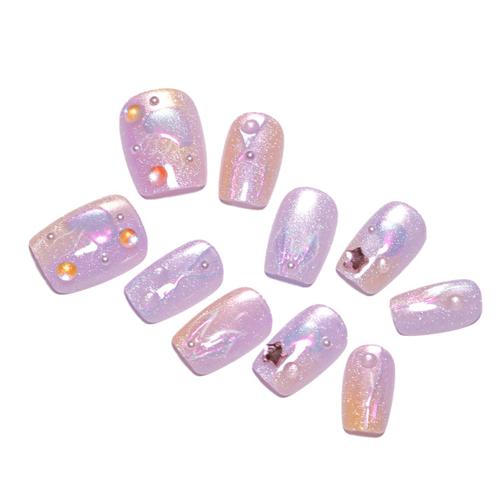 Artificial nail art with sparkling accents and transparent color gradient Stornfield