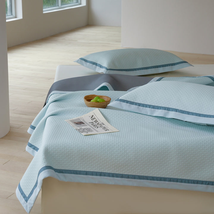 Quilted bedspread with textured waffle pattern and pillowcases